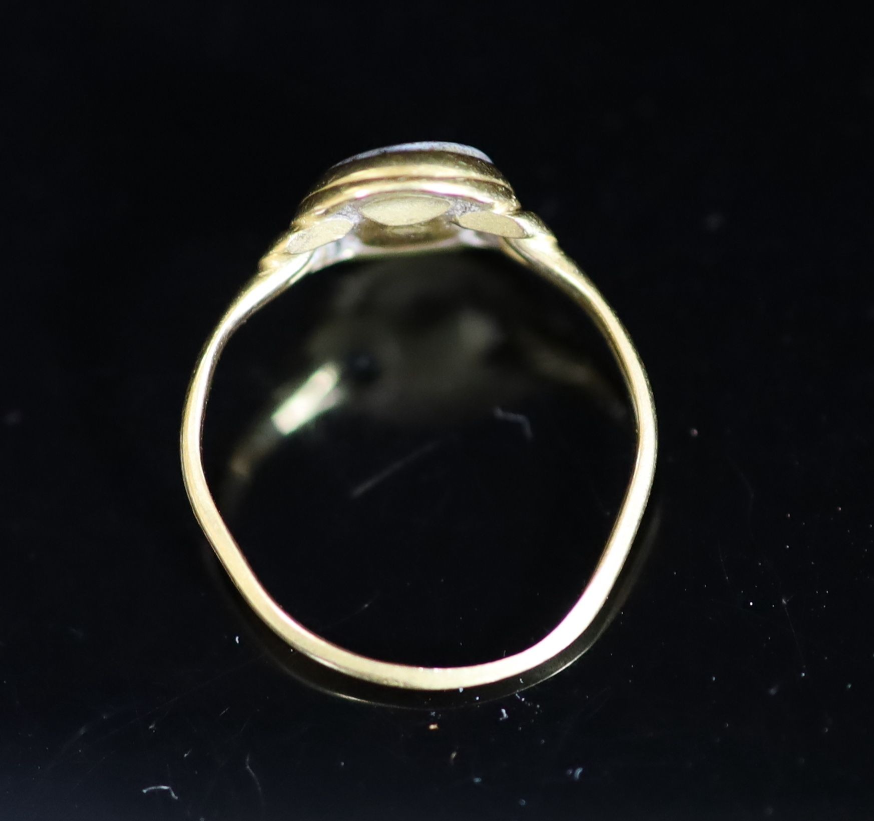 An antique gold and oval chalcedony set ring, carved with the name 'Amelia'
